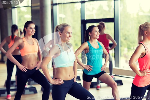 Image of group of women working out with steppers in gym