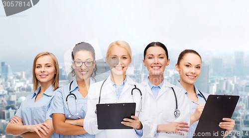 Image of smiling female doctors and nurses with stethoscope