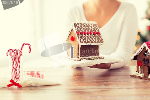 Image of close up of woman showing gingerbread house