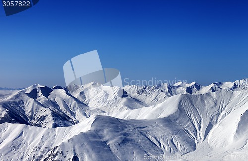 Image of Winter snowy mountains with avalanche slope at evening