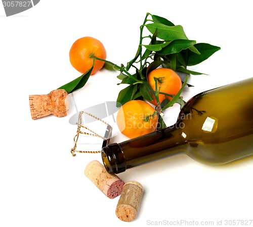 Image of Empty bottle of wine, corks, muselet and mandarins