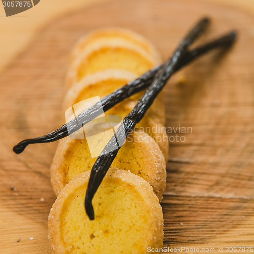 Image of Fresh baked shortbread cookies with  with vanilla sticks on a wood