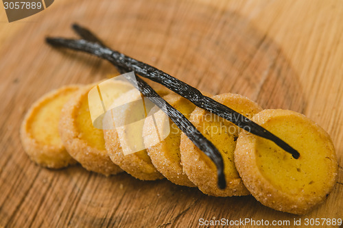 Image of Fresh baked shortbread cookies with  with vanilla sticks on a wood