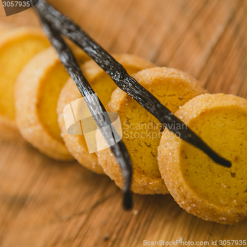 Image of Fresh baked shortbread cookies with  with vanilla sticks on a wood