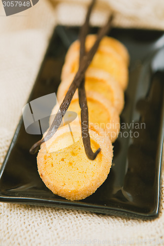 Image of Fresh baked shortbread cookies with  with vanilla sticks on a wood