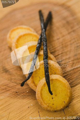 Image of Fresh baked shortbread cookies with  with vanilla sticks on a wood