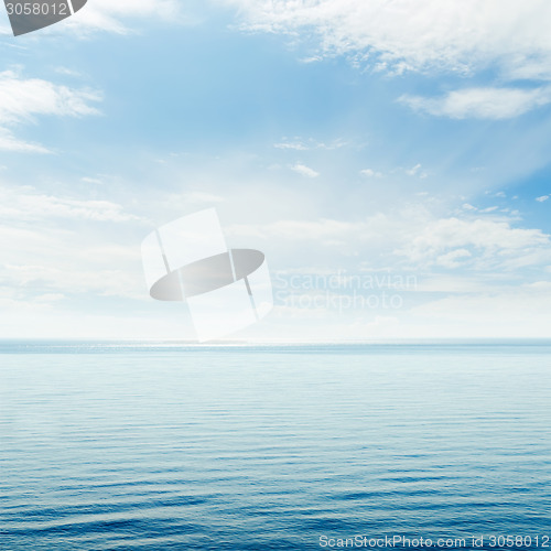 Image of blue sea and cloudy sky over it