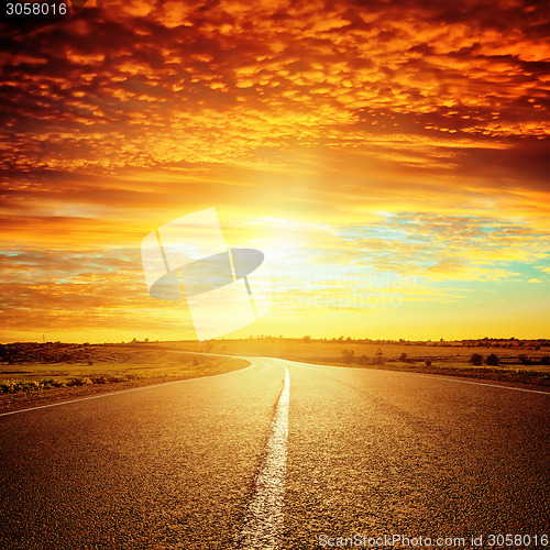 Image of good red sunset and asphalt road to horizon