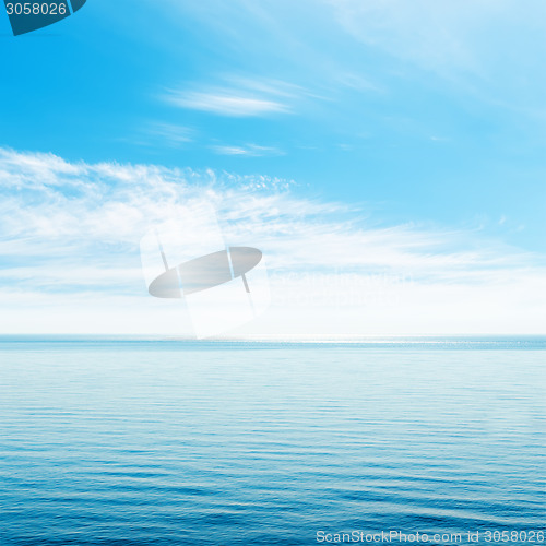 Image of blue sky with clouds over sea