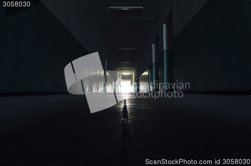 Image of dark corridor with light in horizon