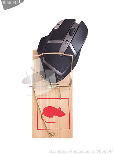 Image of Modern computer mouse in a mousetrap