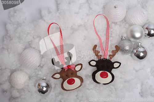 Image of Christmas deer and balls on snow