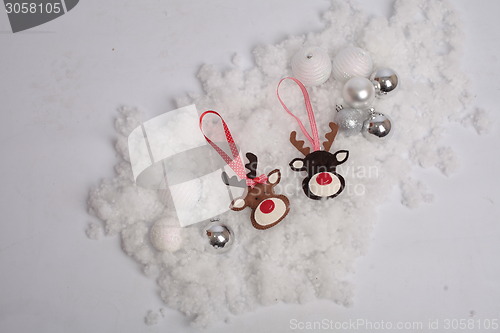 Image of Christmas deer and balls on snow