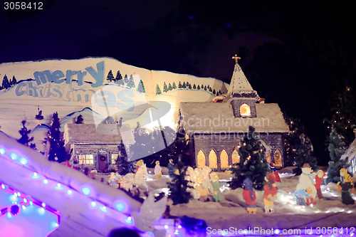 Image of Merry Christmas and village scene with church