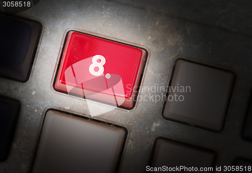 Image of Red button on a dirty old panel