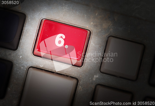 Image of Red button on a dirty old panel
