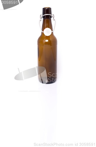 Image of Old brown bottle of beer isolated on white.