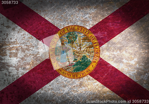 Image of Old rusty metal sign with a flag