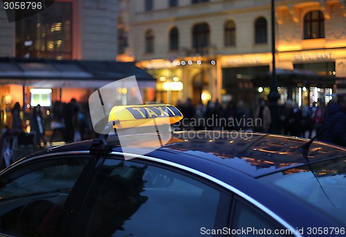 Image of Taxi sign at night 