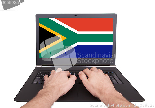 Image of Hands working on laptop, South Africa