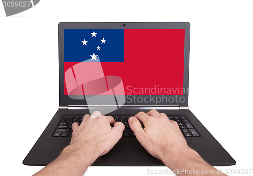 Image of Hands working on laptop, Samoa