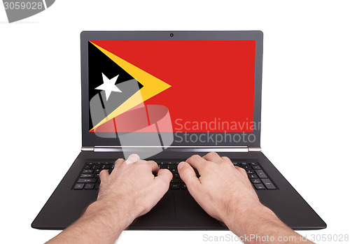 Image of Hands working on laptop, East Timor