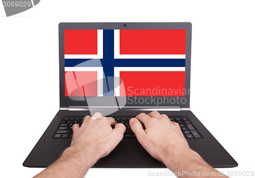 Image of Hands working on laptop, Norway