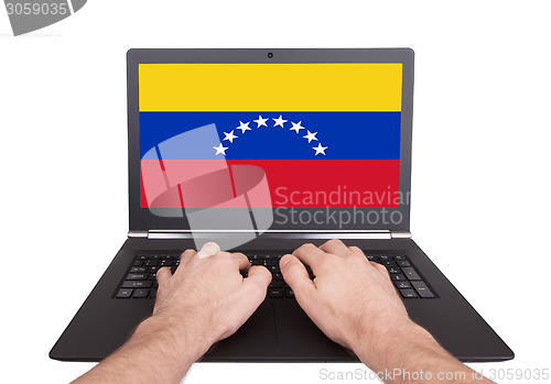Image of Hands working on laptop, Venezuela