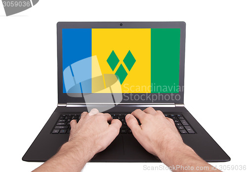 Image of Hands working on laptop, Saint Vincent and the Grenadines