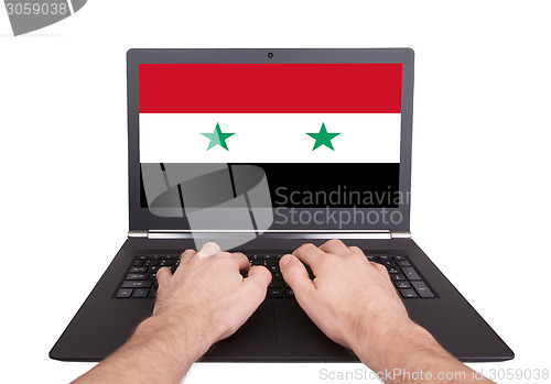 Image of Hands working on laptop, Syria