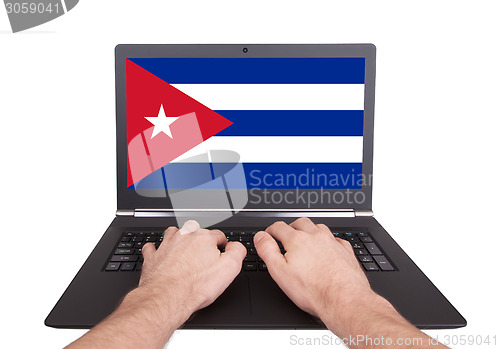 Image of Hands working on laptop, Cuba