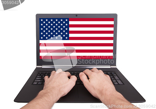 Image of Hands working on laptop, USA