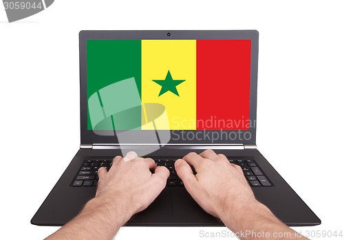 Image of Hands working on laptop, Senegal