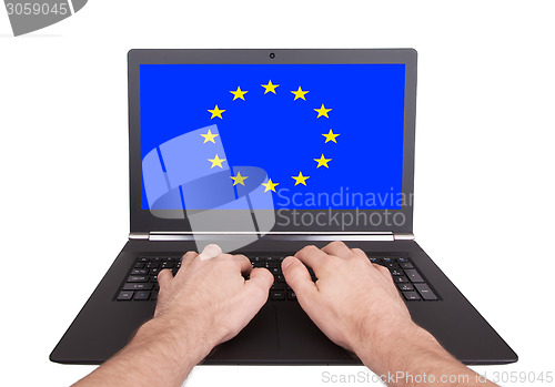 Image of Hands working on laptop, European Union