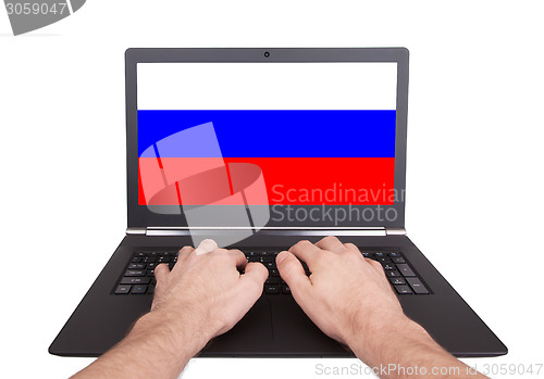 Image of Hands working on laptop, Russia
