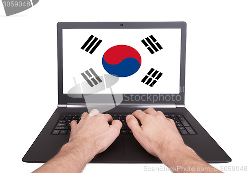 Image of Hands working on laptop, South Korea