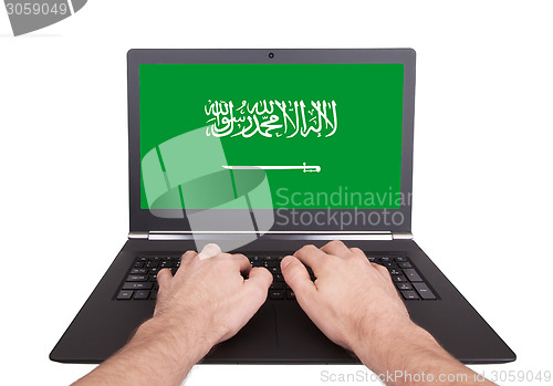 Image of Hands working on laptop, Saudi Arabia