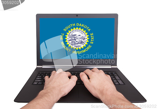 Image of Hands working on laptop, South Dakota