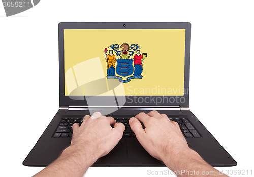 Image of Hands working on laptop, New Jersey