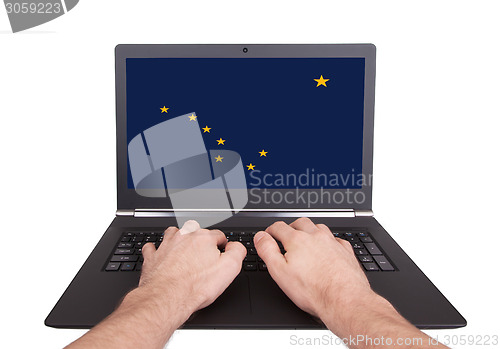 Image of Hands working on laptop, Alaska
