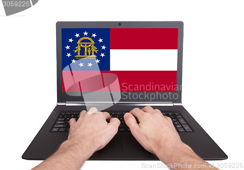 Image of Hands working on laptop, Georgia