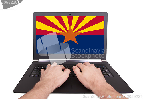 Image of Hands working on laptop, Arizona