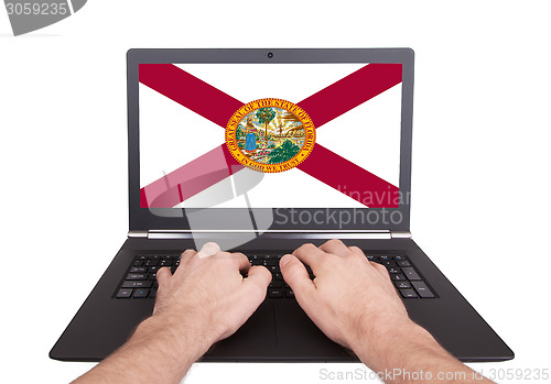 Image of Hands working on laptop, Florida