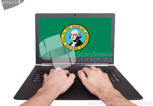 Image of Hands working on laptop, Washington