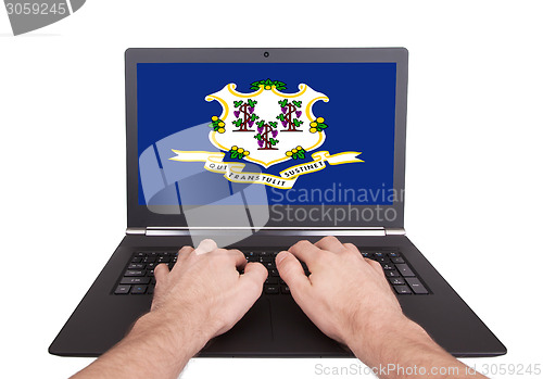 Image of Hands working on laptop, Connecticut