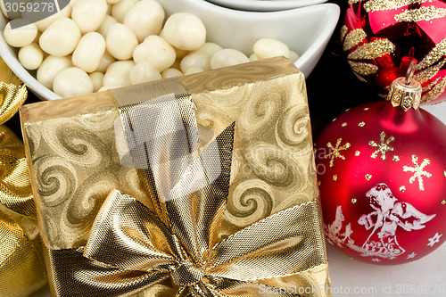 Image of christmas decoration and golden box with ribbon
