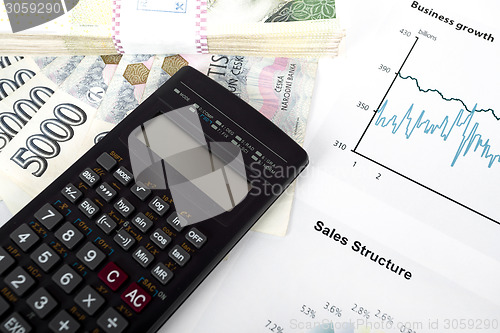 Image of calculator, charts, pen, business workplace