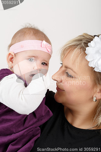 Image of Loving mother embracing her baby girl