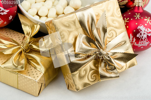 Image of christmas decoration and golden box with ribbon