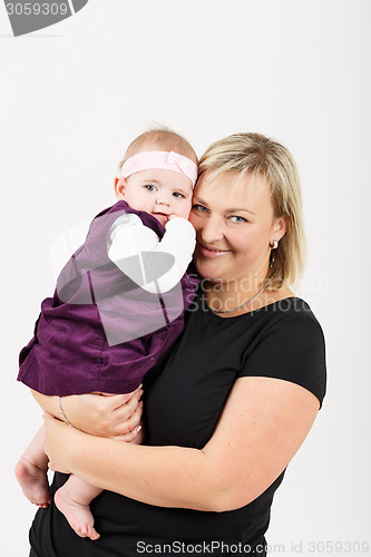 Image of Loving mother embracing her baby girl